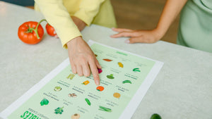 Holistic Nutritionist Pointing to Plant-Based Food Chart