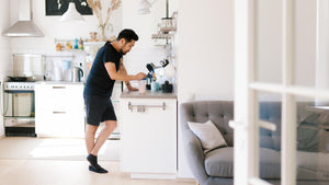 Fit man making a healthy protein shake at home